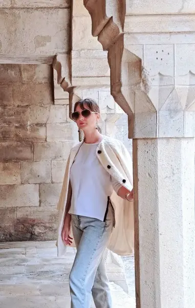 Genç kadın dışarıda beyaz önlüklü poz veriyor. Yüksek kalite fotoğraf