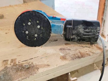 Electric sander in dust after work . High quality photo