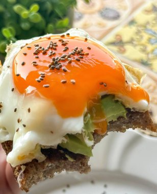 Homemade avocado toast with whole wheat bread, avocado slices and soft-boiled egg served for breakfast on a Sunday with the family clipart