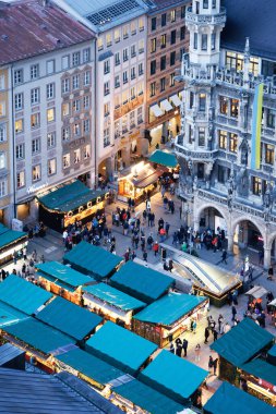 Lively Christmas market at Munich's Marienplatz with decorated Christmas tree and festive atmosphere for the Advent season clipart