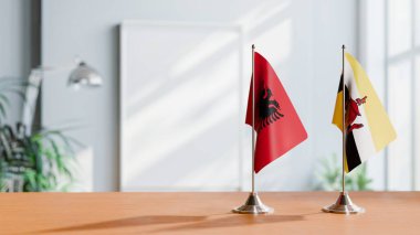 FLAGS OF ALBANIA AND BRUNEI ON TABLE clipart