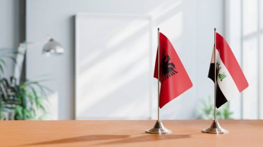 FLAGS OF ALBANIA AND IRAQ ON TABLE clipart