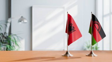 FLAGS OF ALBANIA AND MALAWI ON TABLE clipart