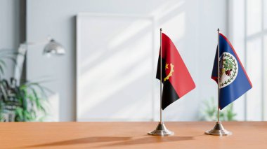 FLAGS OF  ANGOLA AND BELIZE  ON TABLE clipart