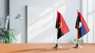 FLAGS OF  ANGOLA AND LAOS  ON TABLE clipart