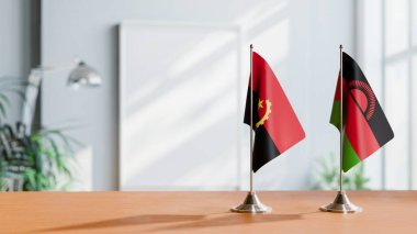 FLAGS OF  ANGOLA AND MALAWI  ON TABLE clipart