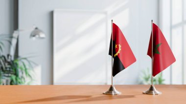 FLAGS OF  ANGOLA AND MOROCCO  ON TABLE clipart