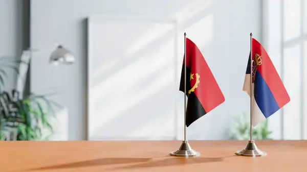 stock image FLAGS OF  ANGOLA AND SERBIA  ON TABLE