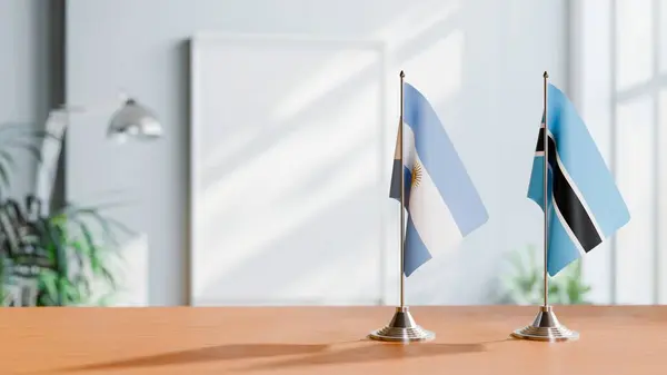 stock image FLAGS OF  ARGENTINA AND BOTSWANA  ON TABLE