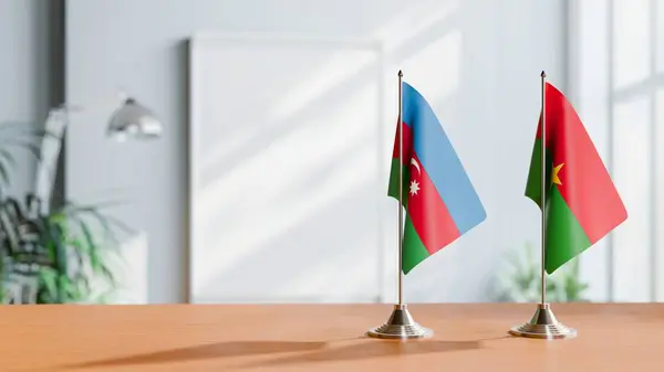 stock image FLAGS OF  AZERBAIJAN AND BURKINA-FASO  ON TABLE