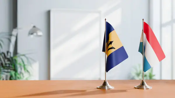 stock image FLAGS OF  BARBADOS AND LUXEMBOURG  ON TABLE