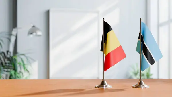 stock image FLAGS OF  BELGIUM AND BOTSWANA  ON TABLE