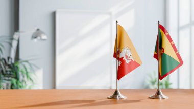 Masanın üzerinde BHUTAN ve GRENADA 'nın bayrağı