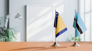 FLAGS OF BOSNIA AND BOTSWANA ON TABLE