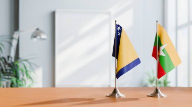 FLAGS OF BOSNIA AND MYANMAR ON TABLE