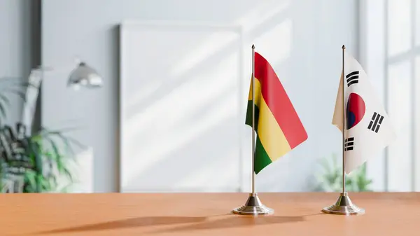 stock image FLAGS OF BOLIVIA AND KOREA SOUTH ON TABLE