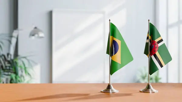 stock image FLAGS OF BRAZIL AND DOMINICA ON TABLE