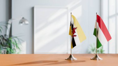 FLAGS OF BRUNEI AND HUNGARY ON TABLE