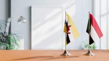 Masanın üzerinde bruney ve Sudan bayrakları