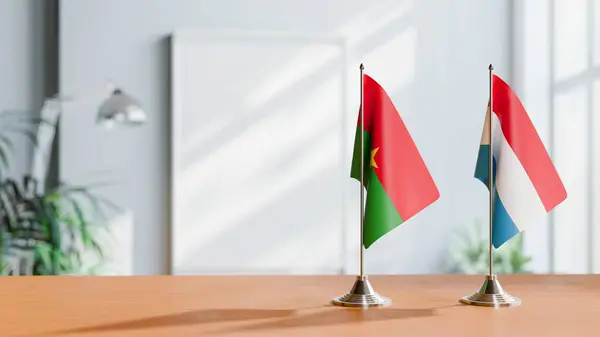 stock image FLAGS OF BURKINA-FASO AND LUXEMBOURG ON TABLE