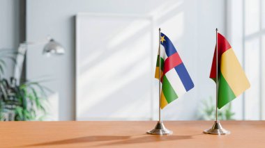 FLAGS OF CENTRAL AFRICAN REPUBLIC AND GUINEA-BISSAU ON TABLE