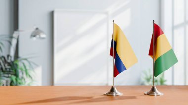 FLAGS OF COLOMBIA AND GUINEA ON TABLE