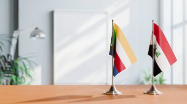 FLAGS OF COMOROS AND IRAQ ON TABLE clipart