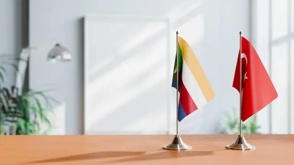 Stock image FLAGS OF COMOROS AND TURKEY ON TABLE