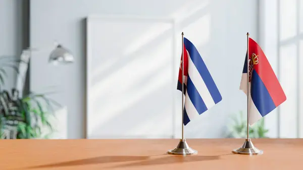 stock image FLAGS OF CUBA AND SERBIA ON TABLE