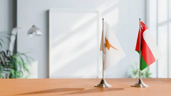 Stock image FLAGS OF CYPRUS AND OMAN ON TABLE