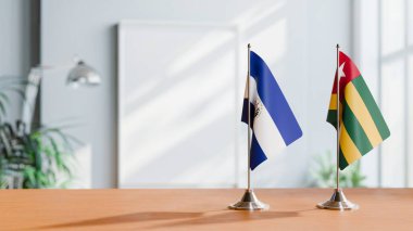 FLAGS OF EL SALVADOR AND TOGO ON TABLE clipart