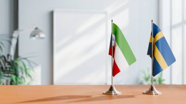 Eşitlikçi Guinea 'nın bayrakları ve Masanın Üzerinde İsveçliler