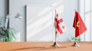 FLAGS OF GEORGIA AND VIETNAM ON TABLE