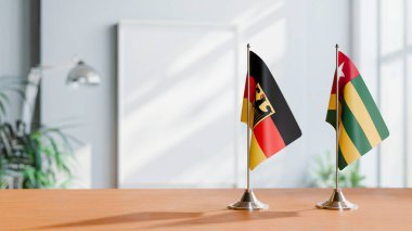 FLAGS OF GERMANY AND TOGO ON TABLE clipart