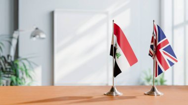 FLAGS OF IRAQ AND UNITED KINGDOM ON TABLE clipart