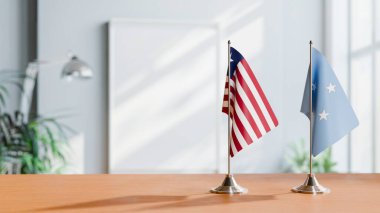 FLAGS OF LIBERIA AND MICRONESIA ON TABLE clipart