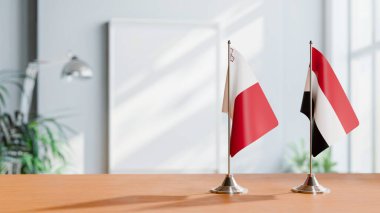 FLAGS OF MALTA AND YEMEN ON TABLE clipart