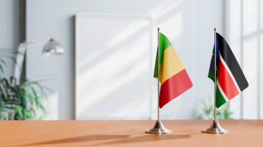 FLAGS OF MALI AND SOUTH SUDAN ON TABLE clipart