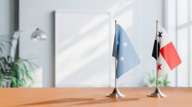 FLAGS OF MICRONESIA AND PANAMA ON TABLE clipart