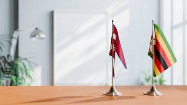 FLAGS OF NEPAL AND ZIMBABWE ON TABLE clipart