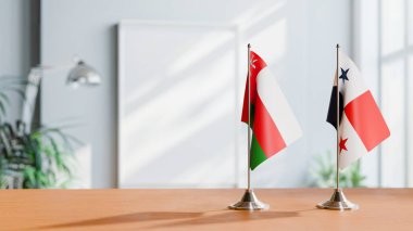 FLAGS OF OMAN AND PANAMA ON TABLE clipart