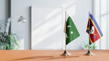 FLAGS OF PAKISTAN AND SWAZILAND ON TABLE clipart