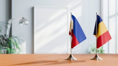 FLAGS OF PHILIPPINES AND ROMANIA ON TABLE clipart