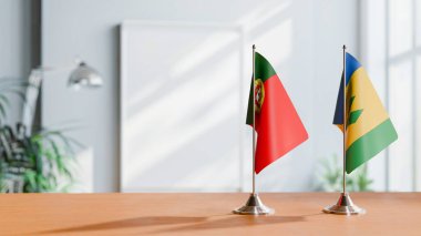 FLAGS OF PORTUGAL AND SAINT VINCENT ON TABLE clipart