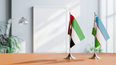 Masanın üzerinde UAE ve UZBEKİSTAN Bayrakları