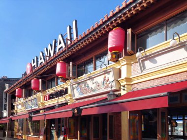 Shophouses & attractions with many food stalls, restaurants, and drinks kiosk at pedestrian Promenade at Batavia Cove Baywalk at Pantai Indah Kapuk (PIK), North Jakarta.  clipart