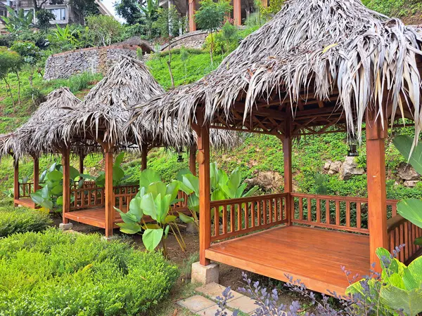 Stock image Typical tropical modern gazebo with wooden floors, timber structure, straws ceiling and palm thatch roof. This gazebo is commonly found in tropical countries and particularly in southeast Asian such as Indonesia, Thailand,