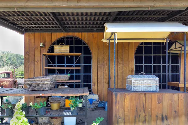 stock image A rustic and vintage barnyard warehouse or hut storing many vintage & traditional potteries, timbers, trellis, ironmongery, and other accessories. 