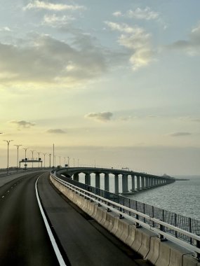 The famous Hong kong-Zhuhai-Macau Brdige or HZMB, the longest bridge in the world spanning accross 50 km above and under the ocean. Taken during beautiful sunset. clipart