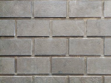 Gri beton blok duvarın pürüzsüz dokusu, geniş gruplandırmalı, düz gri kaldırım taşı duvar..